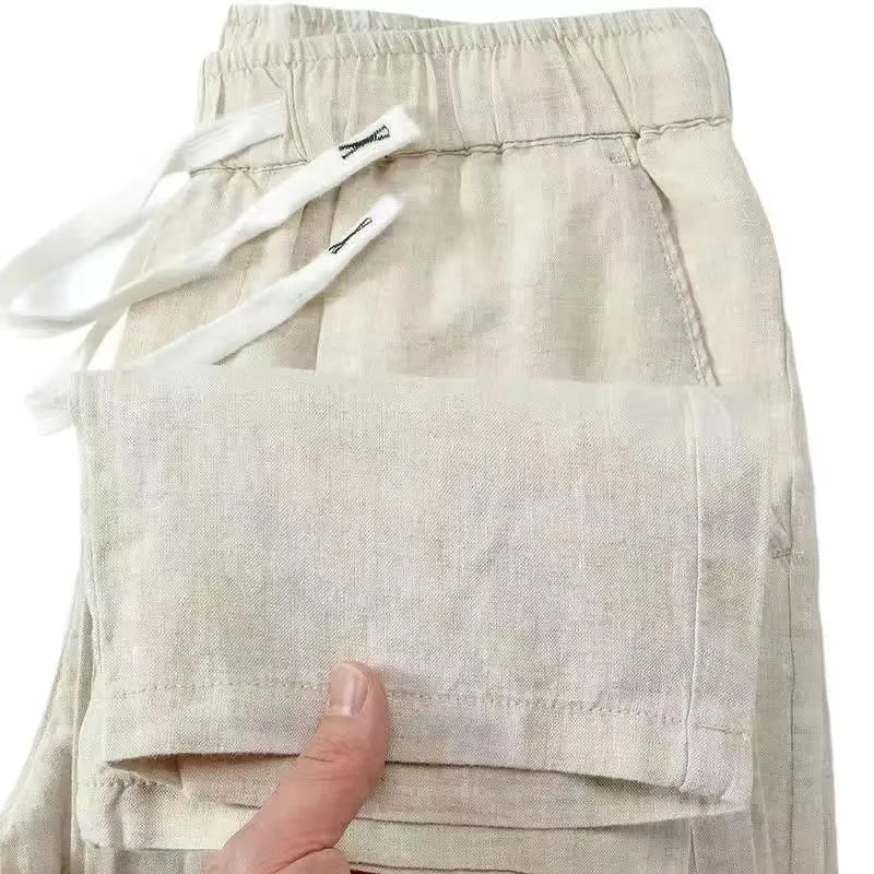 Pure linen Chinese style trousers with elastic drawstring waist in apricot colour showing long straight leg design