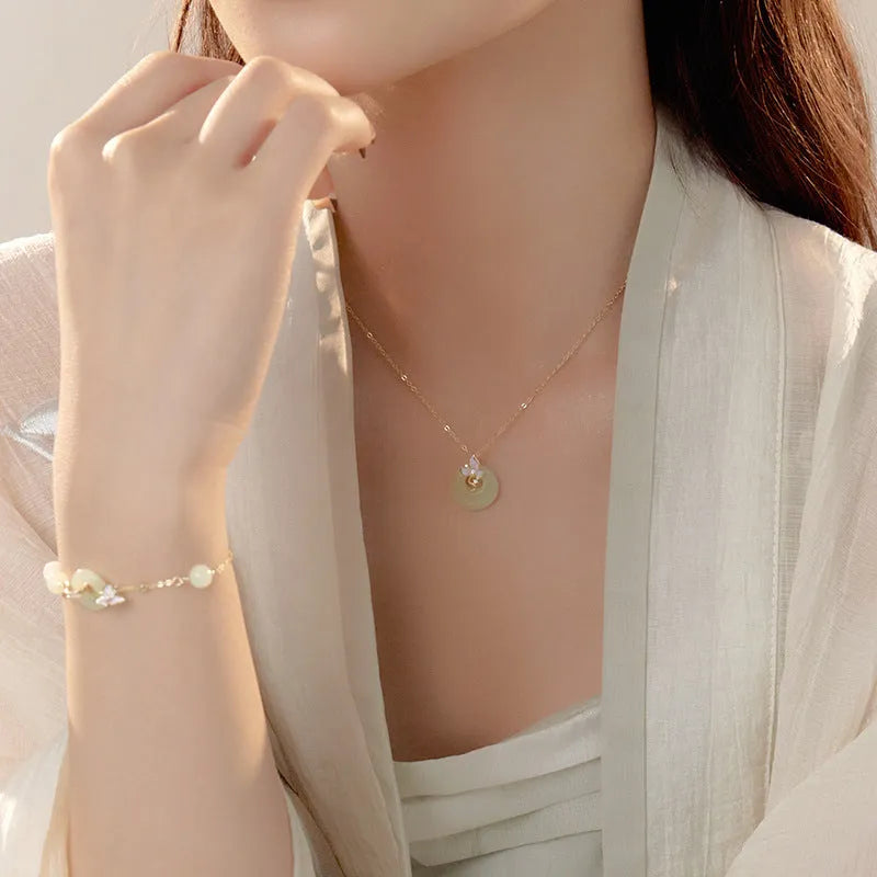 Girl's silver necklace with orchid flower pendant and safety buckle, with matching bracelet.