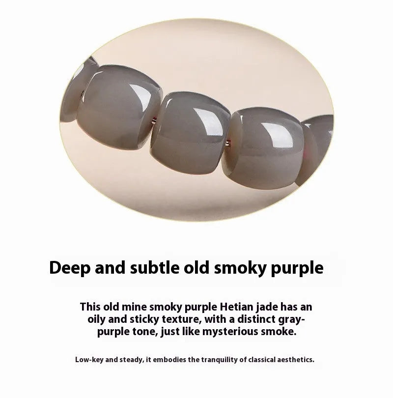 Natural smokey violet Hetian jade bracelet with straight cut beads on a wrist.