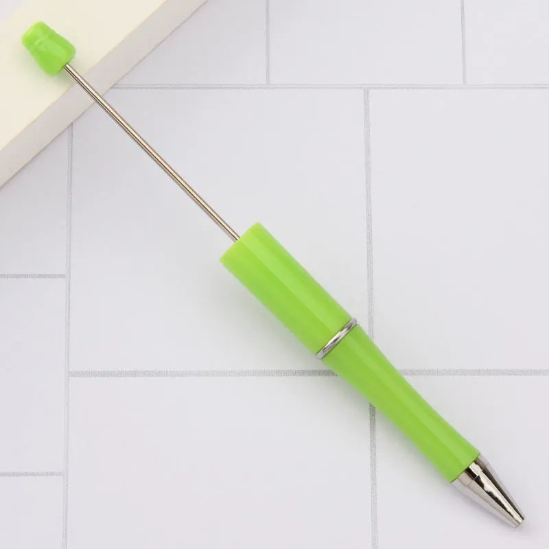 Ballpoint pen with colourful spinning plastic beads on barrel, shown in a gradient purple finish.