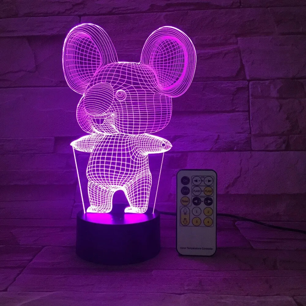 Black koala-shaped LED night light with remote control on a white surface