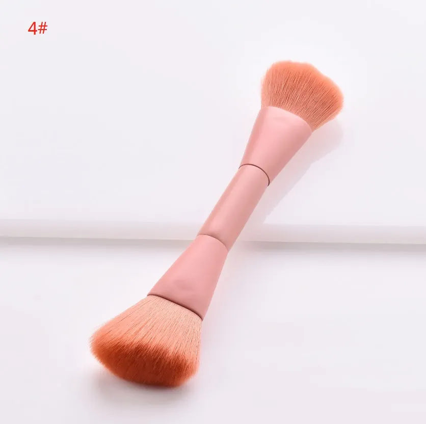 Ten wooden-handle make-up brushes for face and eye application in a pink travel case.