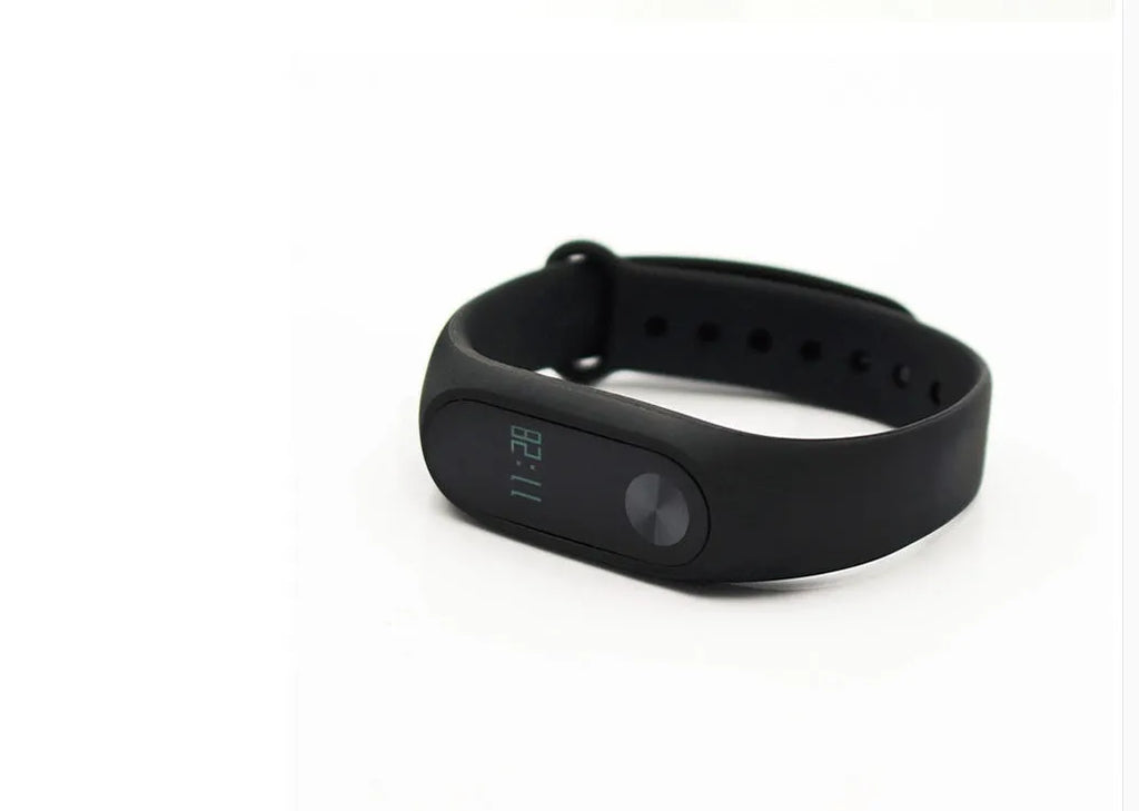Black Xiaomi Mi Band 2 fitness tracker with OLED screen on an adjustable thermoplastic wrist strap.
