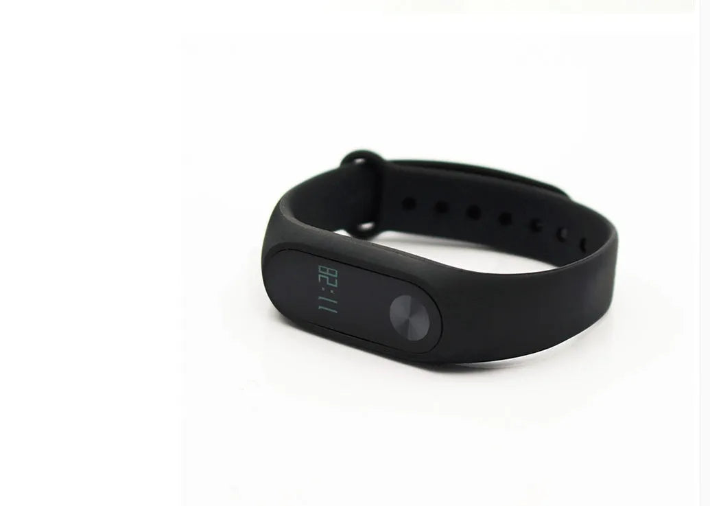 Black Xiaomi Mi Band 2 fitness tracker with OLED screen on an adjustable thermoplastic wrist strap.