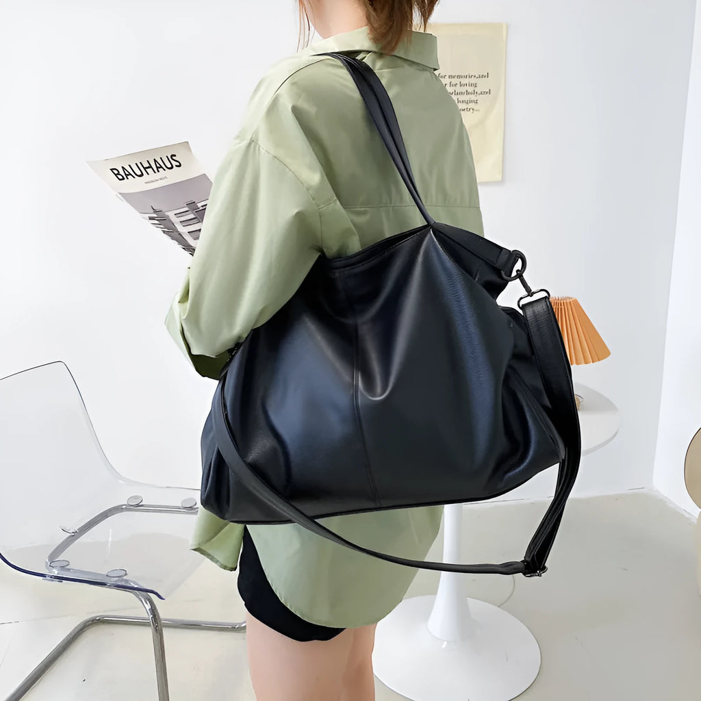Large soft surface messenger bag in horizontal square shape with adjustable shoulder strap and zipper opening