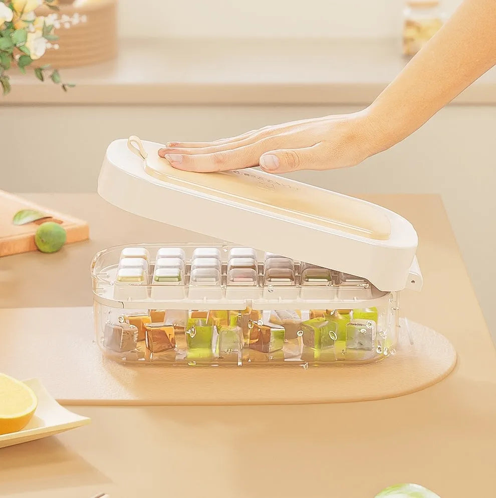 Yellow high-capacity plastic ice cube tray with leverage design and integrated shovel storage slot