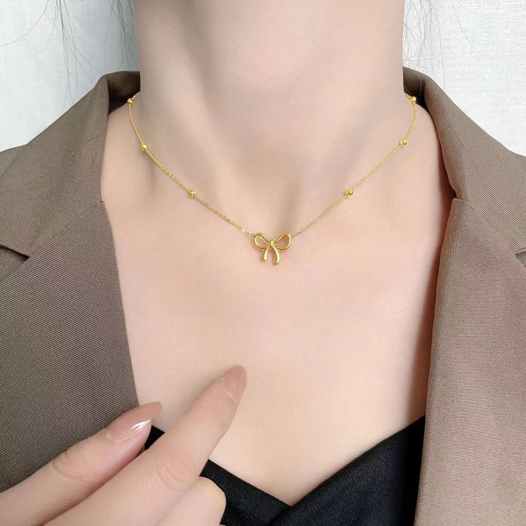 Gold bow necklace on cross chain with adjustable 41-50cm length