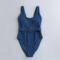 Navy blue women's one-piece swimsuit with triangle design and chest padding on a mannequin.