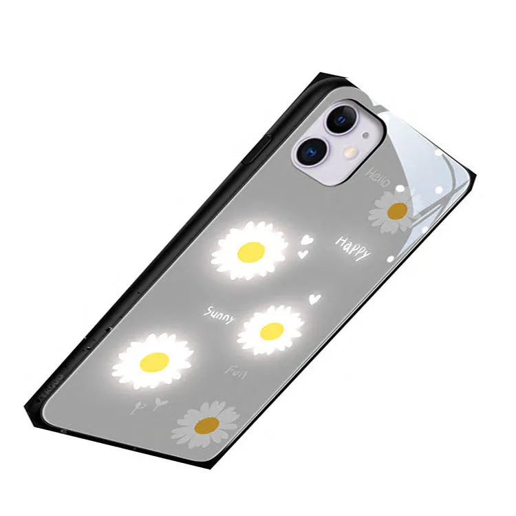 White daisy design luminous iPhone case with voice-activated colour light on a mobile phone.
