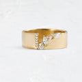 Gold electroplated copper ring for women with shining zircon accents, shown on a finger.