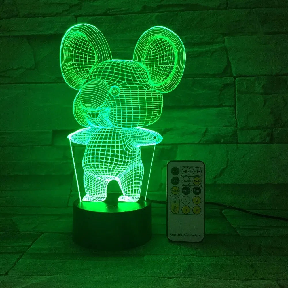 Black koala-shaped LED night light with remote control on a white surface