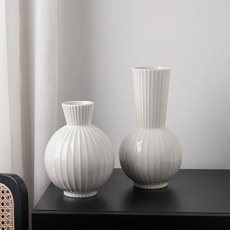 White ceramic ball striped vase in American country style on table with orchid arrangement