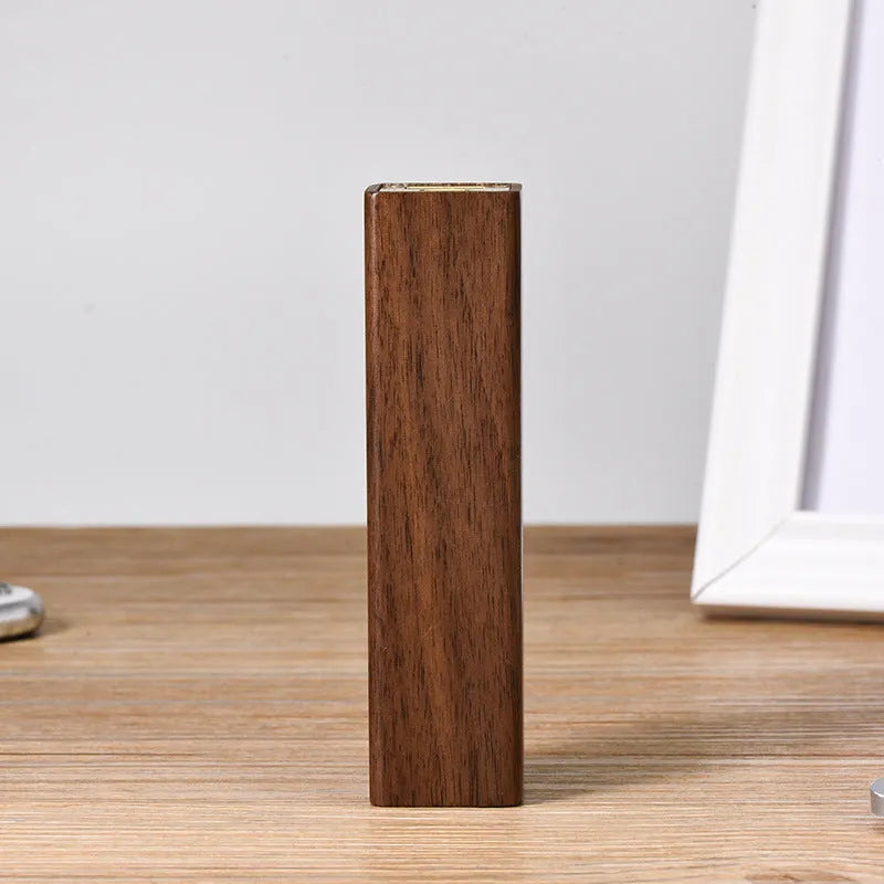 Brown walnut wood portable power bank with USB port showing compact rectangular design.