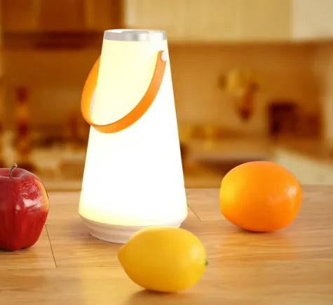 White rechargeable LED bedside lamp with square base measuring 12cm, showing warm white illumination from six LED beads