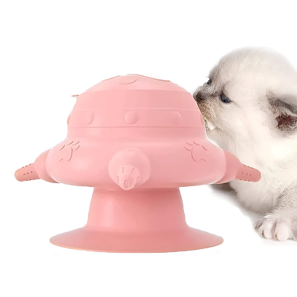 Pink silicone pet nursing device with milk bowl and four pacifiers for puppies and kittens on a flat base.