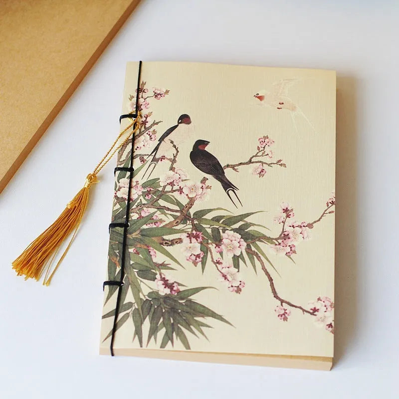 A5 antique wire-bound notebook with glossy embossed cover featuring a retro painting design, shown open.