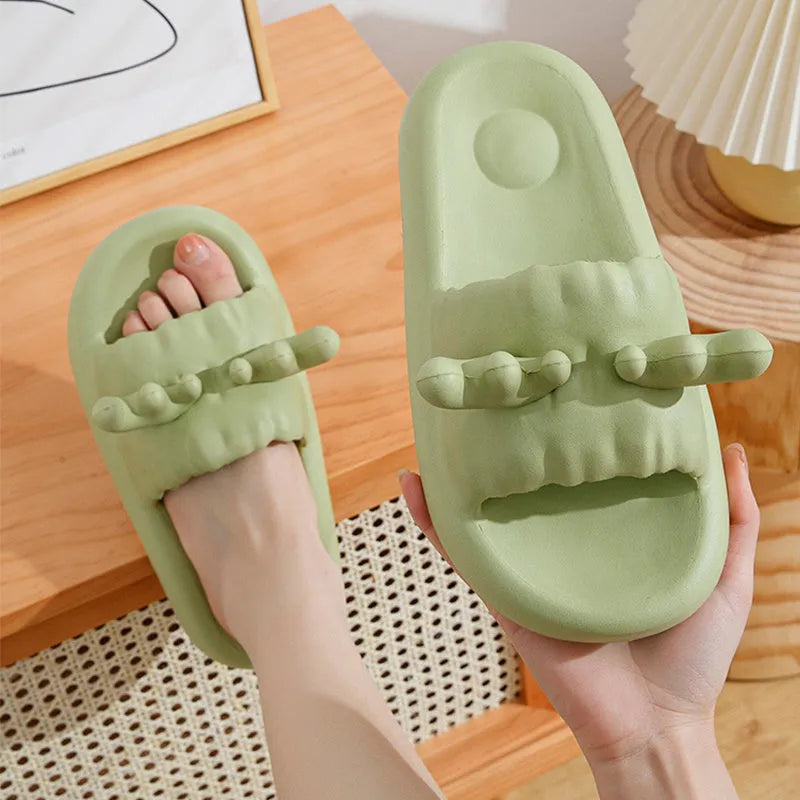 Pair of light-coloured EVA flip flop slippers with hollow-out design and textured sole.