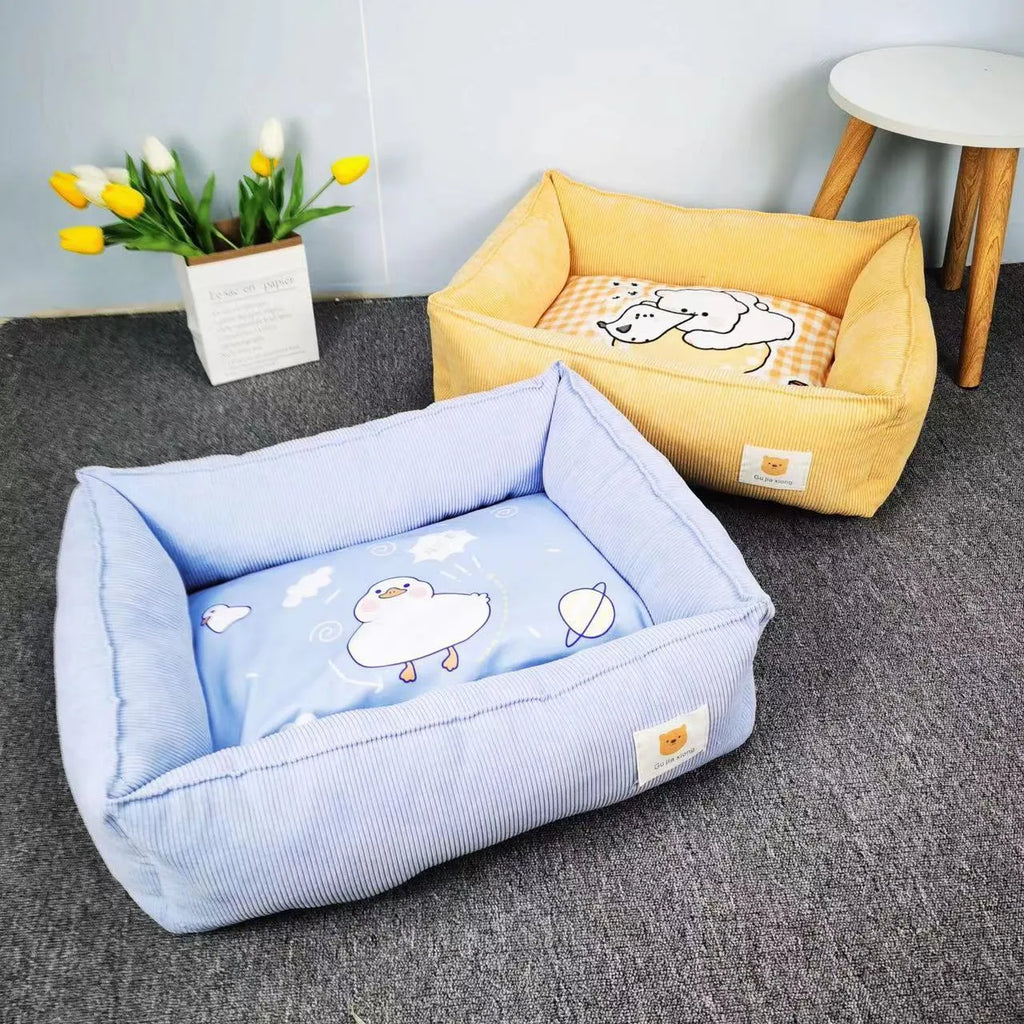 A light blue cotton dog nest with soft lining on a wooden floor.