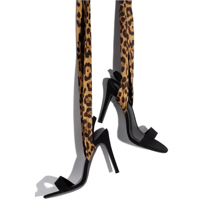 Light brown leopard print women's high heels with cross straps and a fine high heel.