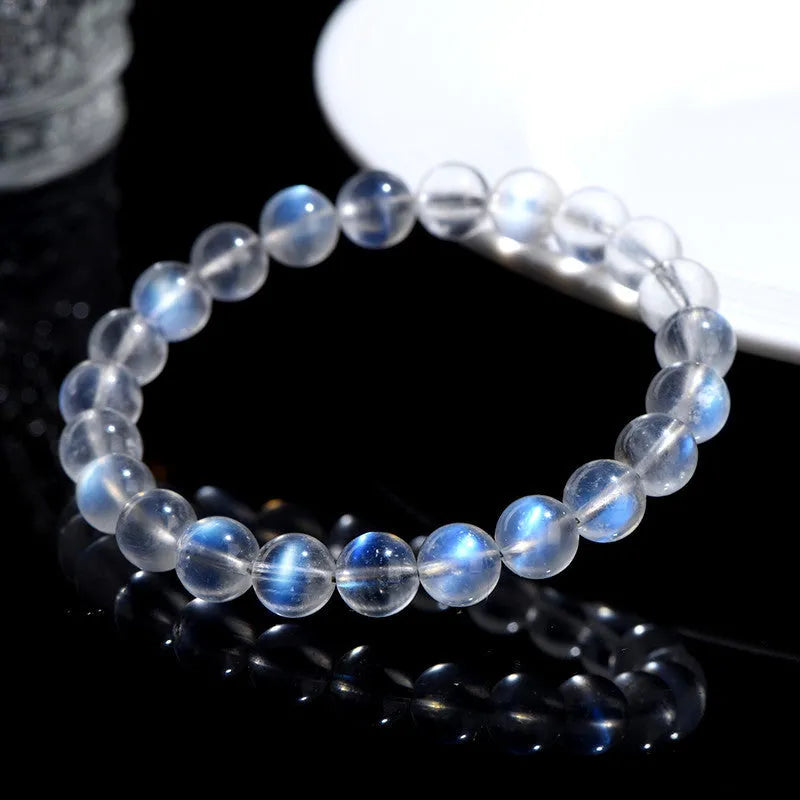 Natural cream body blue moonlight crystal bracelet shown in a simple unisex design on a wrist.