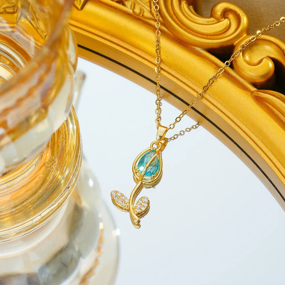 Gold coloured titanium steel necklace with a detailed zircon tulip flower pendant on an O-ring chain.