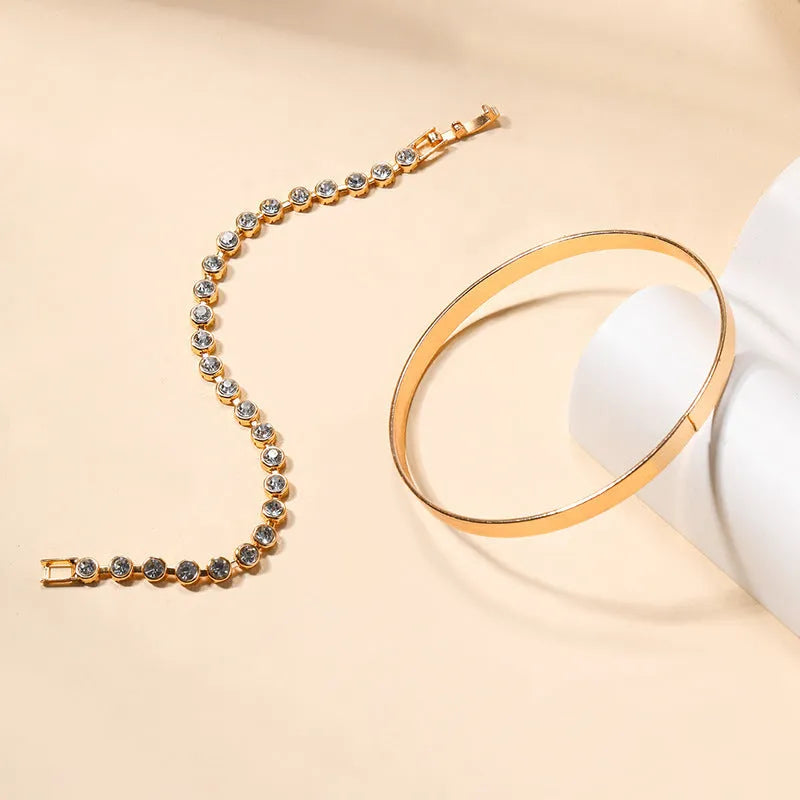 Gold and silver electroplated zinc alloy charm bracelet set with drop, geometric and water droplet details