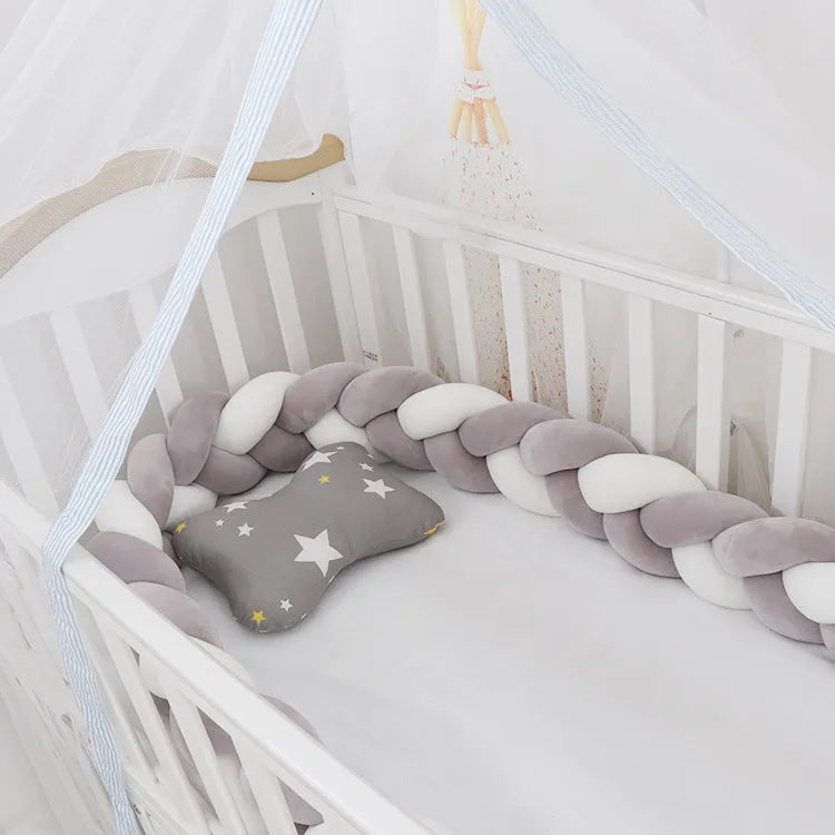 Braided knot design baby crib bumper in spandex velvet, shown in a light grey colour.