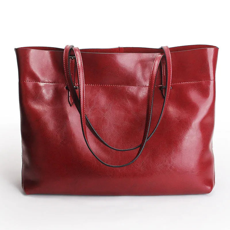 Waxed cowhide leather handbag showing horizontal cross-section opening and internal compartments