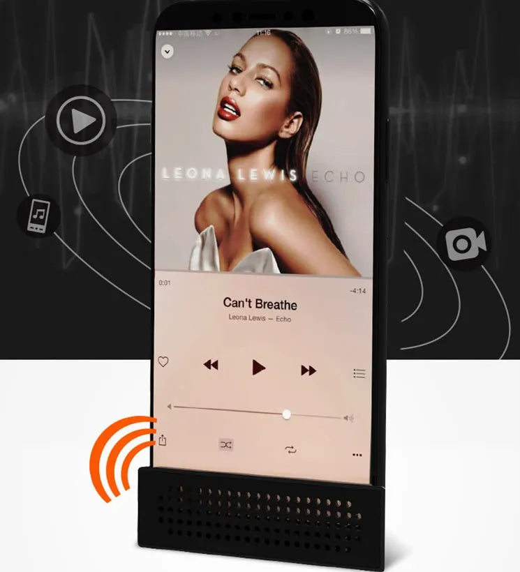 ABS mini mobile phone amplifier bracket in pink, holding a smartphone horizontally on a desktop.