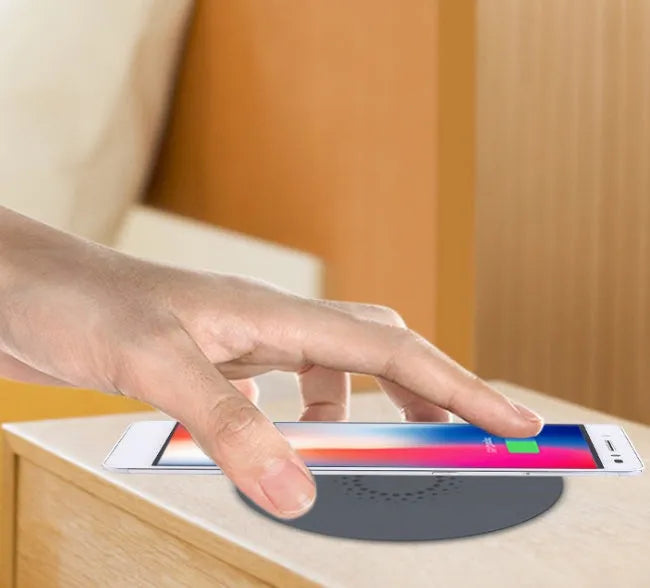 Black round 60mm wireless charging pad for embedded installation in desks and furniture.