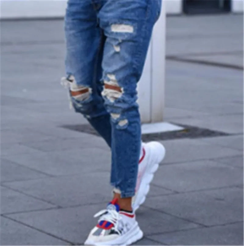 Men's deep blue cotton jeans laid flat, showing button fly and five-pocket design