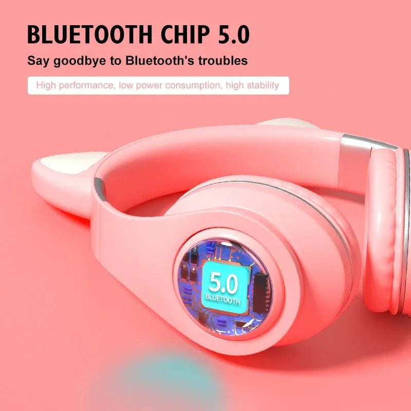 Colourful cat ear style wireless Bluetooth sports headset with a headband, shown in pink.