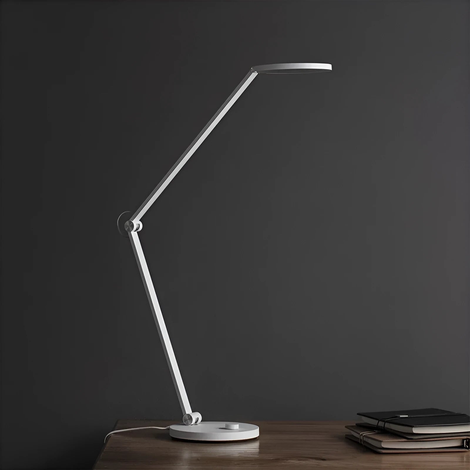 ProLED folding desk lamp with adjustable arm and modern design on a wooden desk.