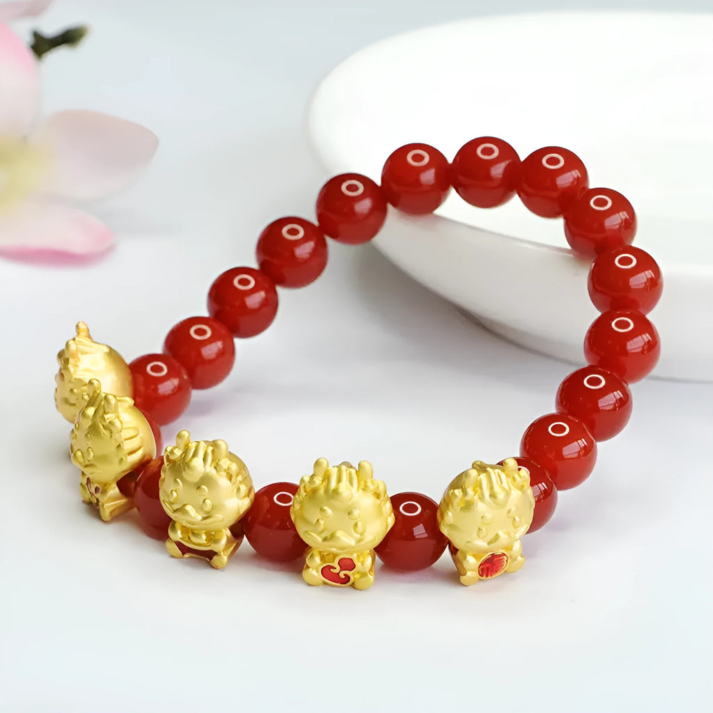 Close-up of a red agate bracelet bead carved with a Chinese Five Blessings Dragon design.