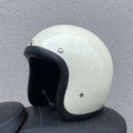 Retro-style half-shell motorcycle helmet in fibreglass, shown in a cement grey colour option.
