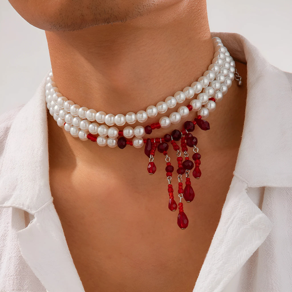 Men's Halloween necklace with red artificial crystal blood drop pendant and black imitation pearl tassels on a metal chain.