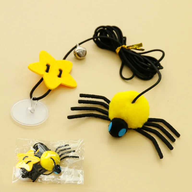 Red and yellow hanging door cat toy with elastic rope, feather, bell, and spider attachments