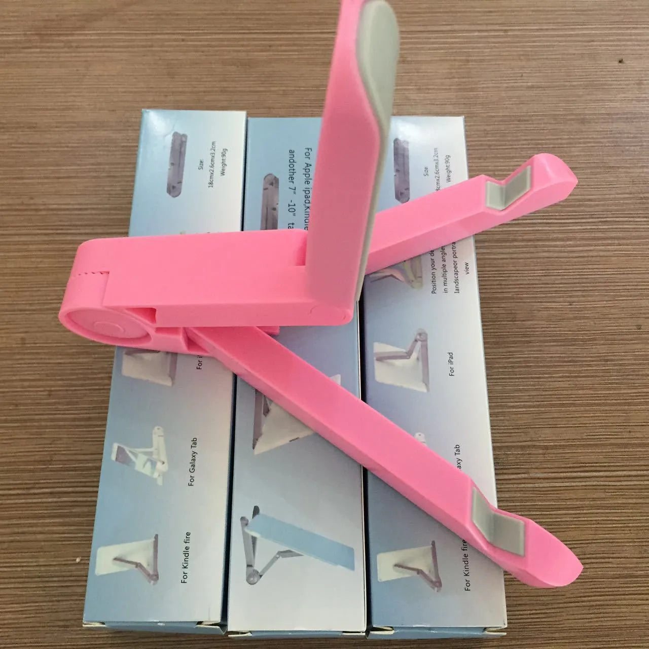 Black foldable aluminium tablet holder showing adjustable angles and flat-folded profile