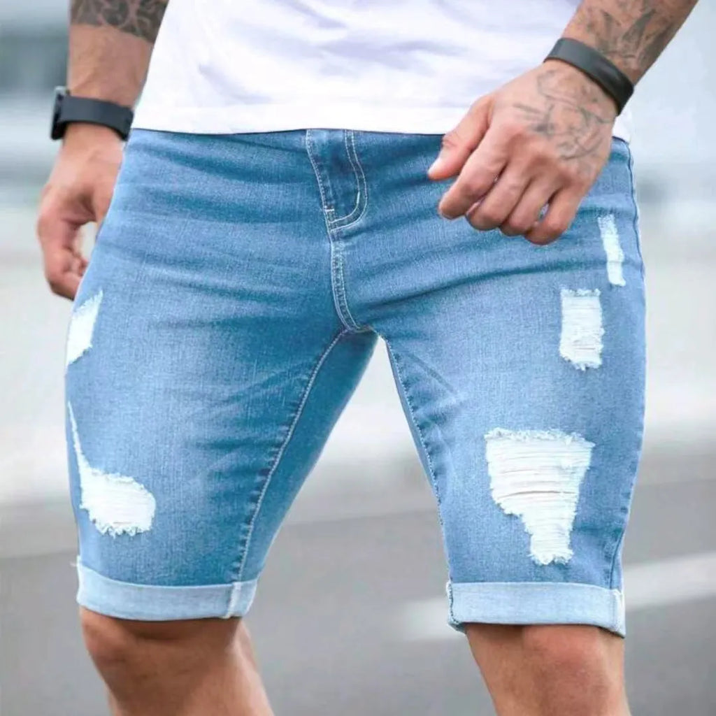 Sky blue men's denim shorts with distressed holes, low waist, and straight leg.