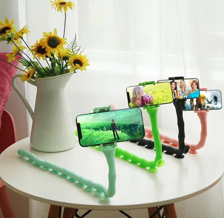 Flexible mobile phone holder with suction cup on desktop showing 360-degree rotation