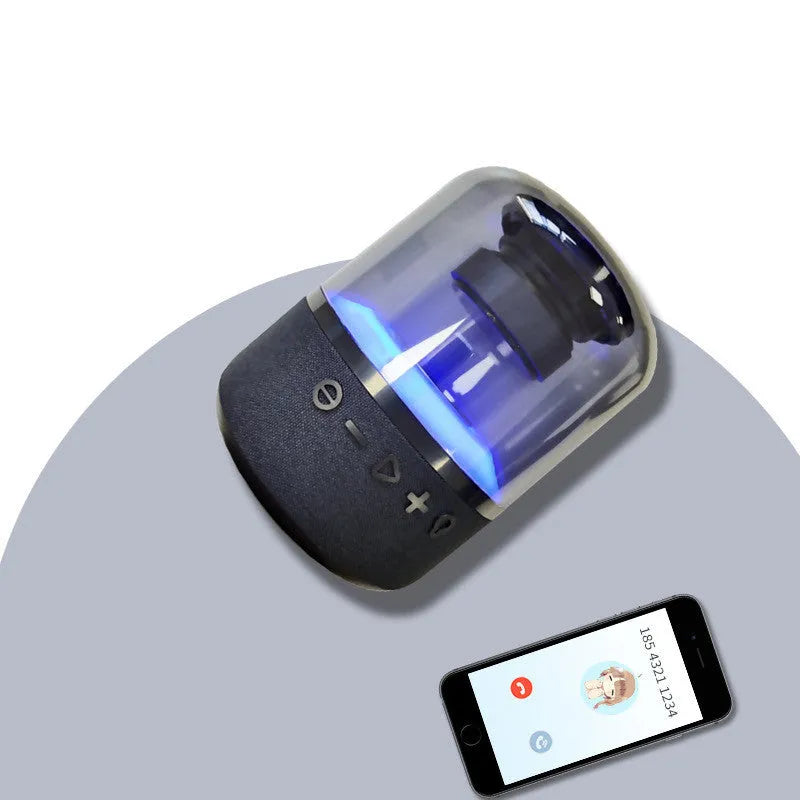 Black wireless Bluetooth speaker with multi-colour LED halo lights glowing around its base.