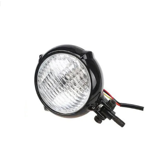 Black electroplated aluminium motorcycle headlight with halogen bulb for classic custom bike builds.