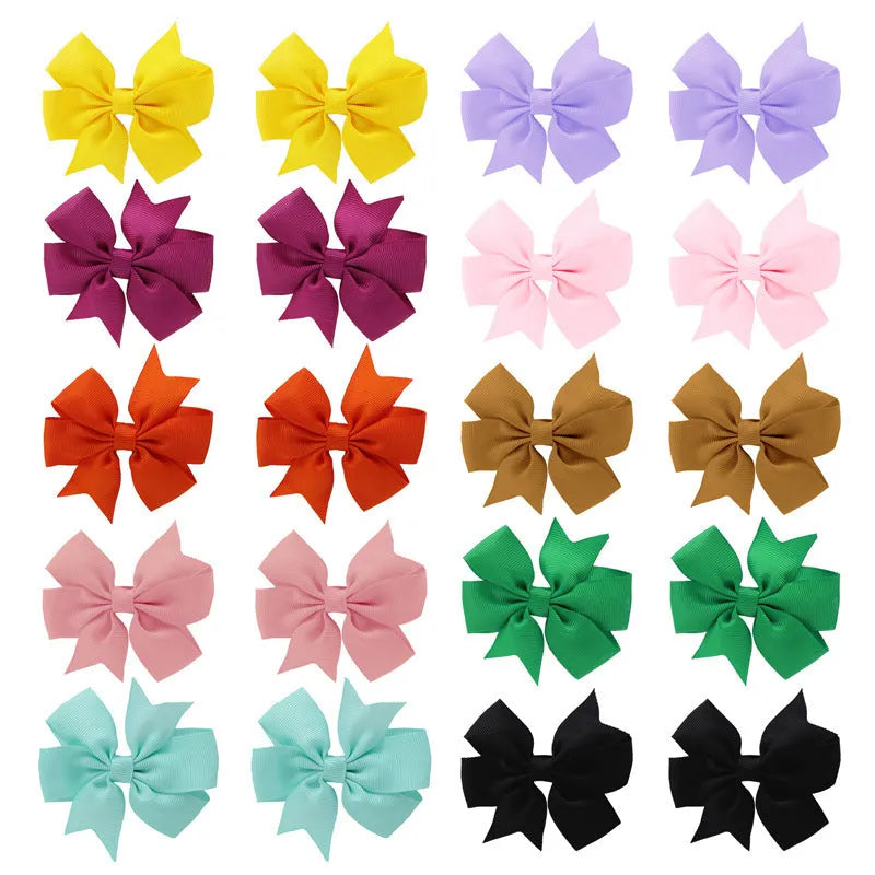Set of 20 colourful 3-inch grosgrain ribbon pinwheel hair bows with alligator clips for toddlers.