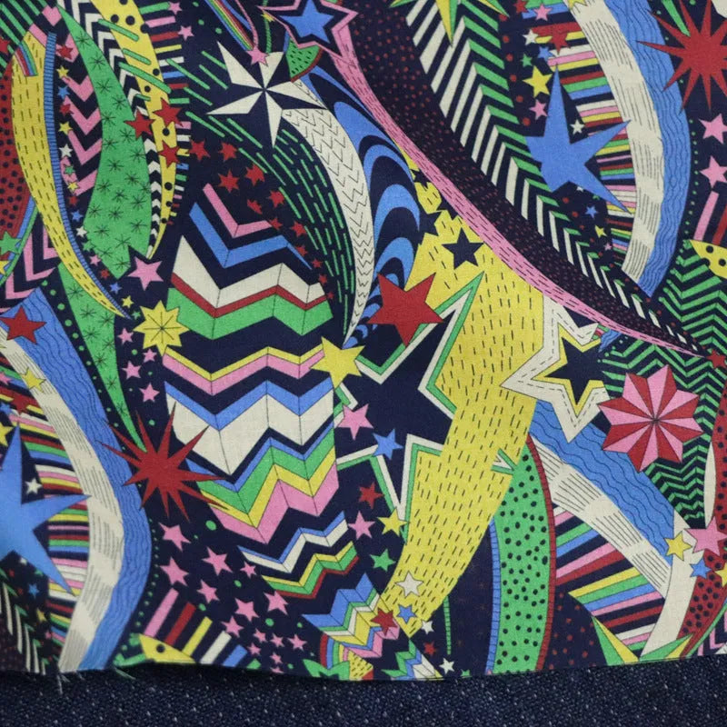 Blue cotton fabric with digital floral printing showing plant designs