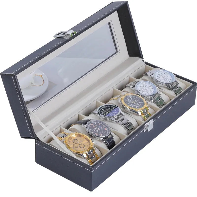 Grey leather watch storage box with transparent lid showing internal watch slots.