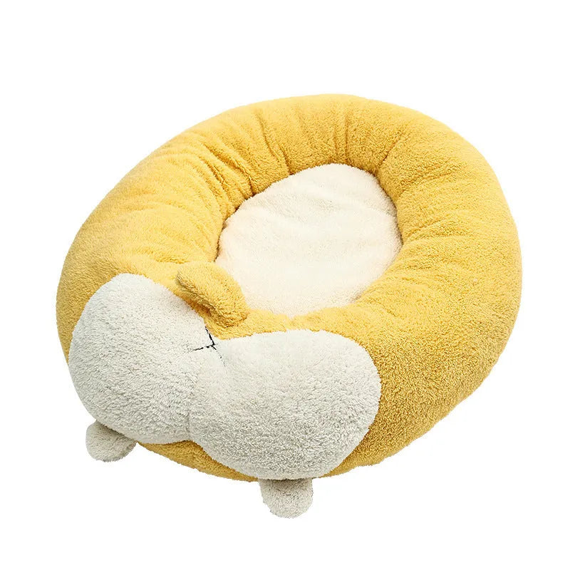 Brown and white corgi-shaped plush dog bed on a wooden floor.