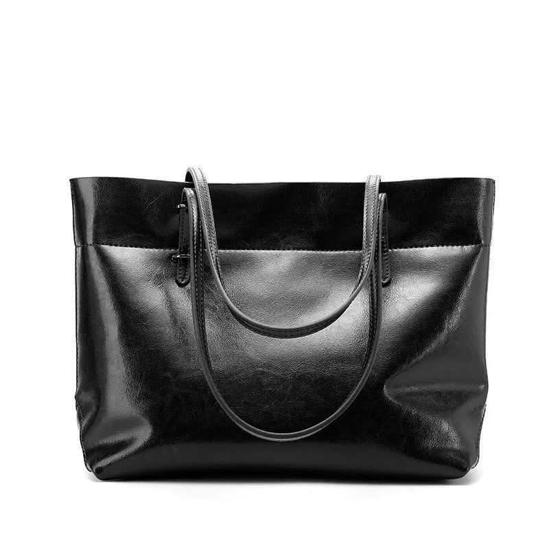 Waxed cowhide leather handbag showing horizontal cross-section opening and internal compartments