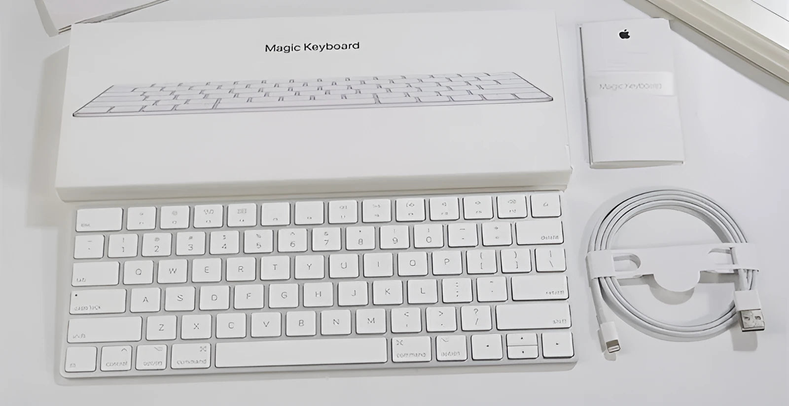White Apple Bluetooth wireless keyboard with ultra-thin metal construction and multimedia function keys