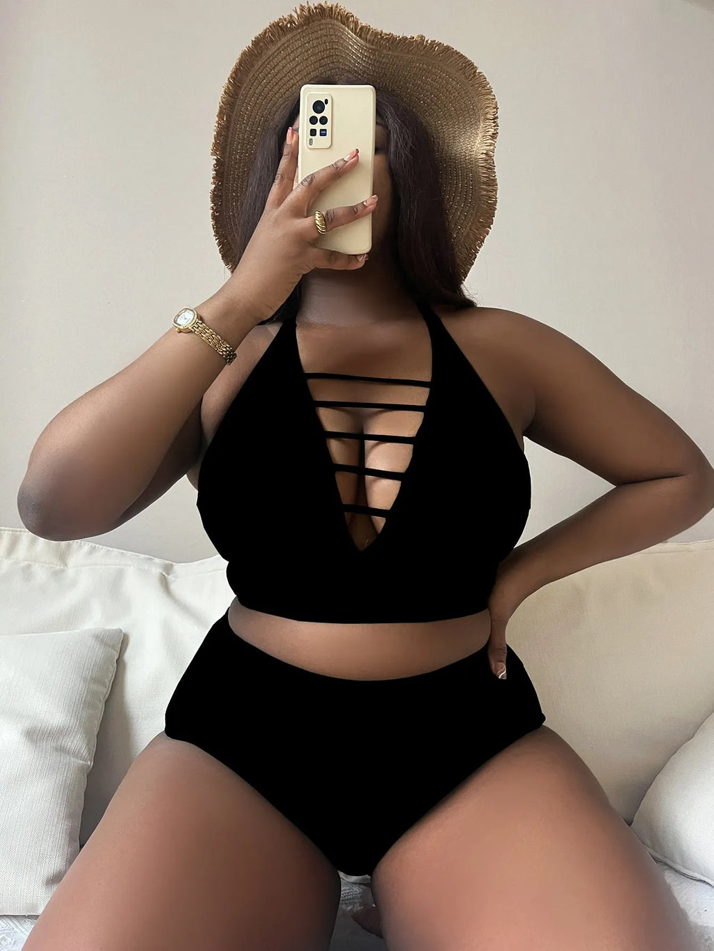 Plus size black halter bikini set with adjustable straps and high-waisted briefs on a mannequin