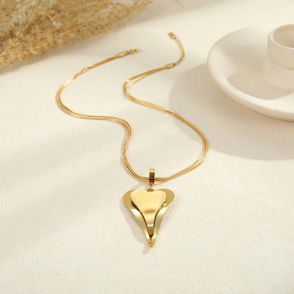 Women's stainless steel necklace with double heart geometric pendant featuring snake bones design in gold plating